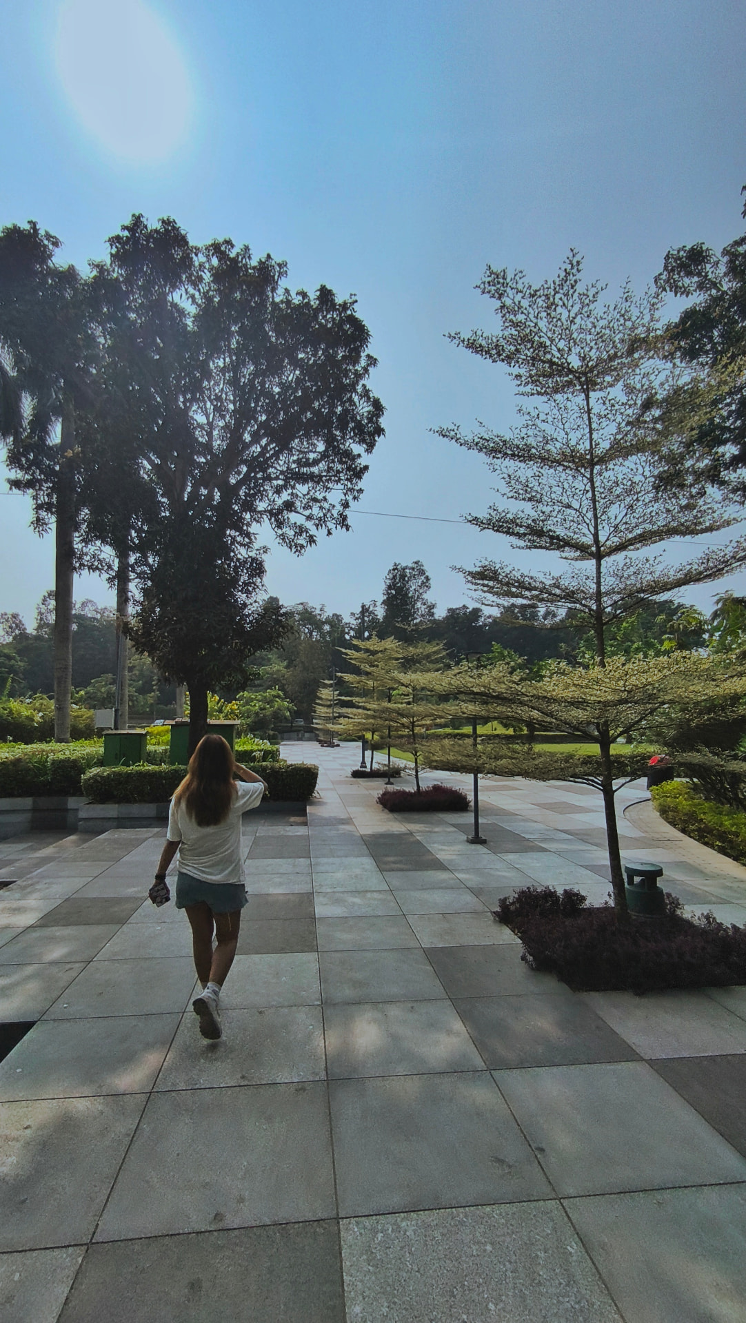 Richa walking ahead in a sunlit park