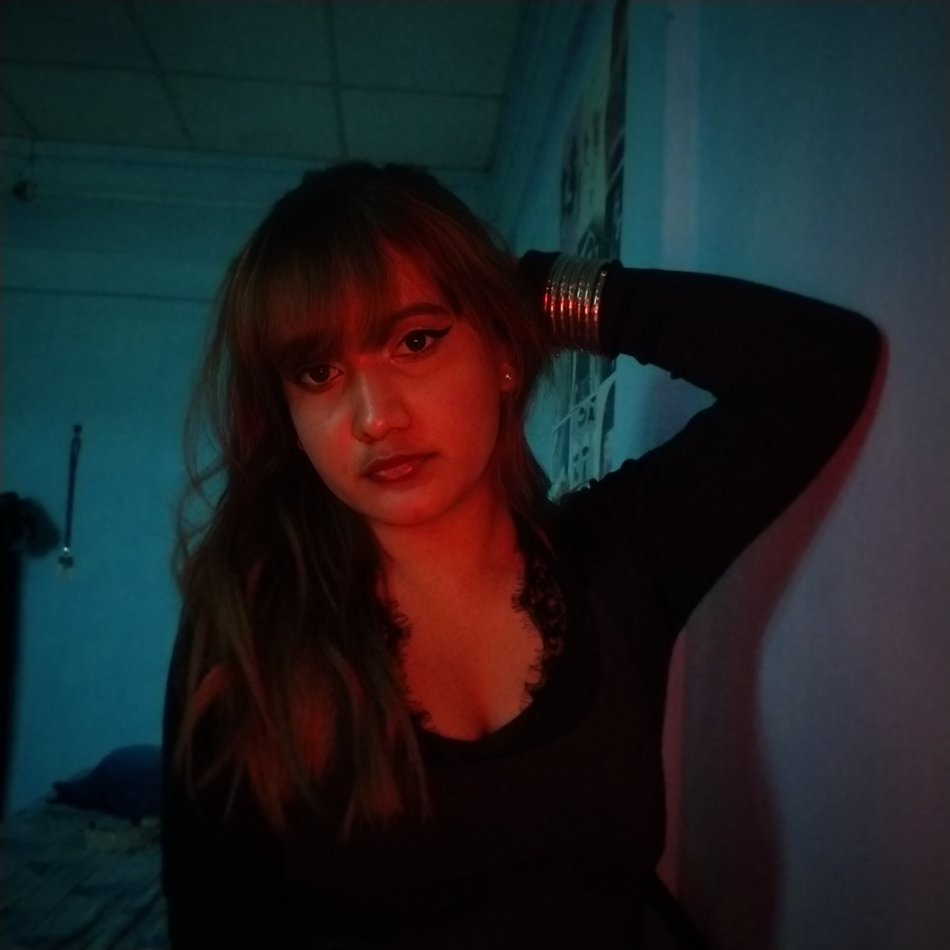 Richa posing in moody red and blue light